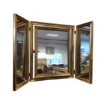 A three-plate gilt framed dressing table mirror, with central easel mounted mirror flanked by hinged