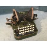 An Edwardian cast iron Oliver typewriter with twin tapering banks of letters/numbers framing the