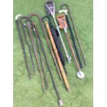 A collection of miscellaneous walking sticks including bamboo with brass screw top, hallmarked