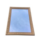 A rectangular mirror in a gilt frame with moulded decoration. (34.25in x 24.25in)