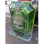 An enamelled cast iron stove by Artesse, the fire with moulded frame having oval hatch above a micra