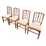 A set of four nineteenth century country elm dining chairs, with arched backs on slender slats above