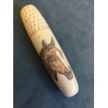 A carved bone needlecase decorated with a penwork horse, having dimpled thimble screw cover. (3.