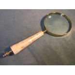 A brass library magnifying glass with tapering mother of pearl panelled handle. (10in)