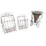 A graduated pair of wrought iron wall baskets, the scrolled enclosures with grill bases - 26in &