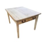 A Victorian pine kitchen table with rectangular top above a plain frieze with compartmentalised