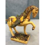 A Chinese sancai glazed tang style horse, the saddled beast with crackled body on rectangular