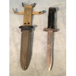 An American M5 army bayonet dagger with tapering steel blade and sprung locking mechanism to handle,