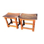 A pair of Thompson of Kilburn rectangular dowel jointed oak mouseman stools with dished seats on