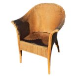 A Lloyd Loom style armchair with rounded back and flared arms, raised on turned bentwood legs &