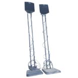 A pair of Alphason Philips speakers mounted on twin poles with rectangular weighted bases. (50in) (