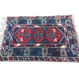 A Turkestan rug woven in the belouchi style with central red field of three crosses with serrated