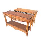 A pair of cane hall tables with rectangular tray tops having rounded projecting corners raised on