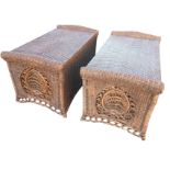 A pair of cane ottoman benches with hinged seats and rounded rolled ends with panels of pierced