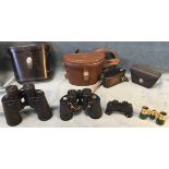 A leather cased set of Canon 7 x 35 binoculars; another similar Nikon pair; a miniature belt pouched