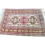 A Turkish rug woven with central totem pole panels on ivory field bordered by serrated diamond