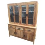 A glazed hardwood cabinet with four glass doors enclosing shelves to top, the dresser base with