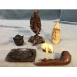 Six carved pieces - a Japanese fisherman, an elephant, a soapstone tribal type figure, a pipe with