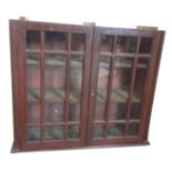 A stained astragal glazed nineteenth century cupboard with moulded glazing bars to doors, flanked by