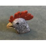 A cold painted bronze vesta modelled as a cockerel head, the sprung hinged oval striking plate