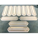 A set of eleven porcelain door finger plates, the shaped panels with gilded decoration. (11in) (11)