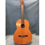 A Spanish classical guitar by Admira, the cedar body with transfer decoration to soundhole, having
