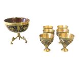 An eighteenth century coconut cup with brass mounts having scrolled crescent shaped panels with