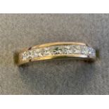 An 18ct yellow gold diamond half eternity ring, the eleven princess cut diamonds set in a channel on