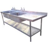 A rectangular stainless steel double sink unit by Sissons of Sheffield mounted with taps having