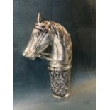 A silver plated cane handle modelled as a bridled horse, above a foliate embossed collar with
