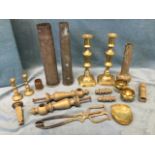 Miscellaneous brass including shell cases, a pair of Victorian candlesticks, a stand, a pair of fire