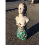 A painted resin moulded ships figurehead modelled as a mermaid on canon type block. (42in)