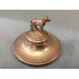 A hallmarked silver dog on circular filled stand, the animal standing alertly on naturalistic