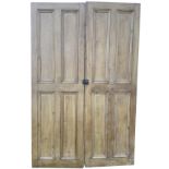 A pair of Victorian pine cupboard doors, each with four moulded panels, mounted with original sprung