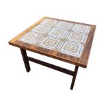 A mid-century danish rosewood coffee table with tiled panelled to top, raised on rectangular