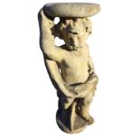 A composition stone figure of a draped cherub supporting a circular platform, standing on plinth