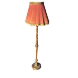 A Victorian standard lamp with pleated tasseled shade on a twisted, tapering and fluted gilt & gesso