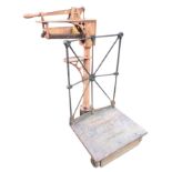 A set of Victorian cast iron sack scales by GH Corderoy, the weighing platform with railing beside a