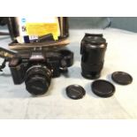 A case Minolta 35mm camera with spare lenses, flash unit, attachments, manuals, etc. (A lot)
