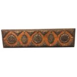 An eastern panel with applied embossed brass mounts set with polished semi-precious stones, the