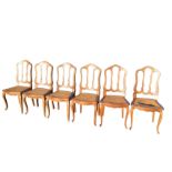 A set of six European oak dining chairs, the moulded backs with three apertures above bowfronted