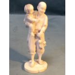A Japanese carved ivory okimono depicting a father & son, he holding child and fruit leaf sprig,
