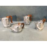 A Picquot Ware four-piece stylised teaset with wood handles. (4)