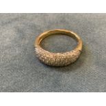 An 18ct yellow gold diamond bombé shaped ring, the mound pave set with round brilliant cut