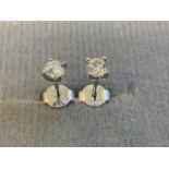 A pair of 18ct white gold diamond stud earrings, the claw set diamonds of over half a carat, with