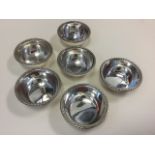 A set of six circular silver European finger bowls with ropetwist rims to tapering bodies - 800