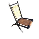 A Victorian ebonised campaign chair, the folding frame with ring-turned back having cane seat and