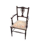 A stained Edwardian armchair, the back with pierced carved splat above a copper studded