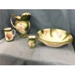A late Victorian Staffordshire three-piece wash set with an associated jug, decorated with floral
