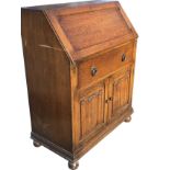 An 1930s oak bureau, with moulded fallfront revealing fitted interior with shelves and